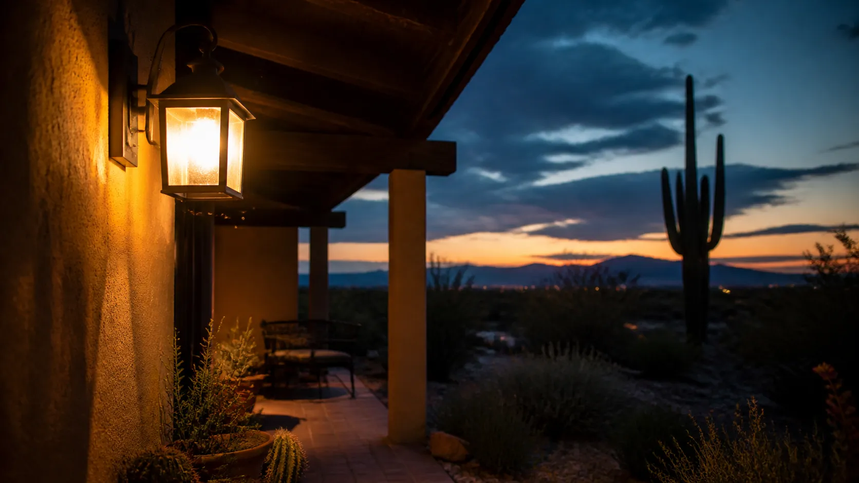Porch light glowing at dusk outside a Tucson foothills home during kissing bug season